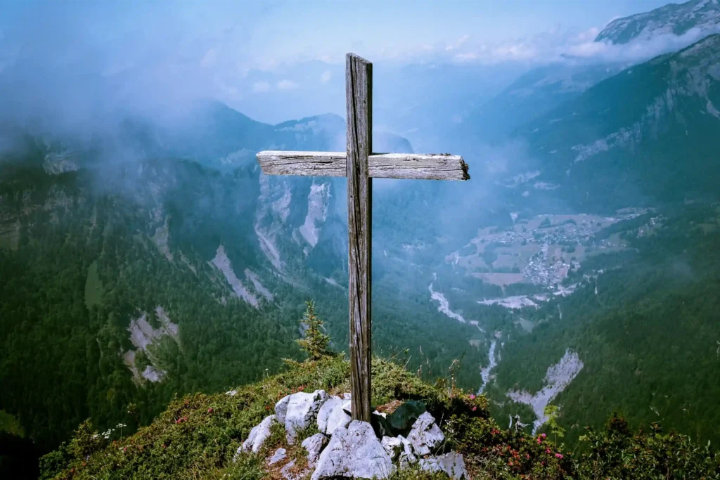 a wooden cross on a mountaintop